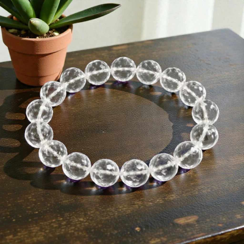 Crystal Quartz Diamond Cut bracelet on a wooden surface with a potted plant in the background