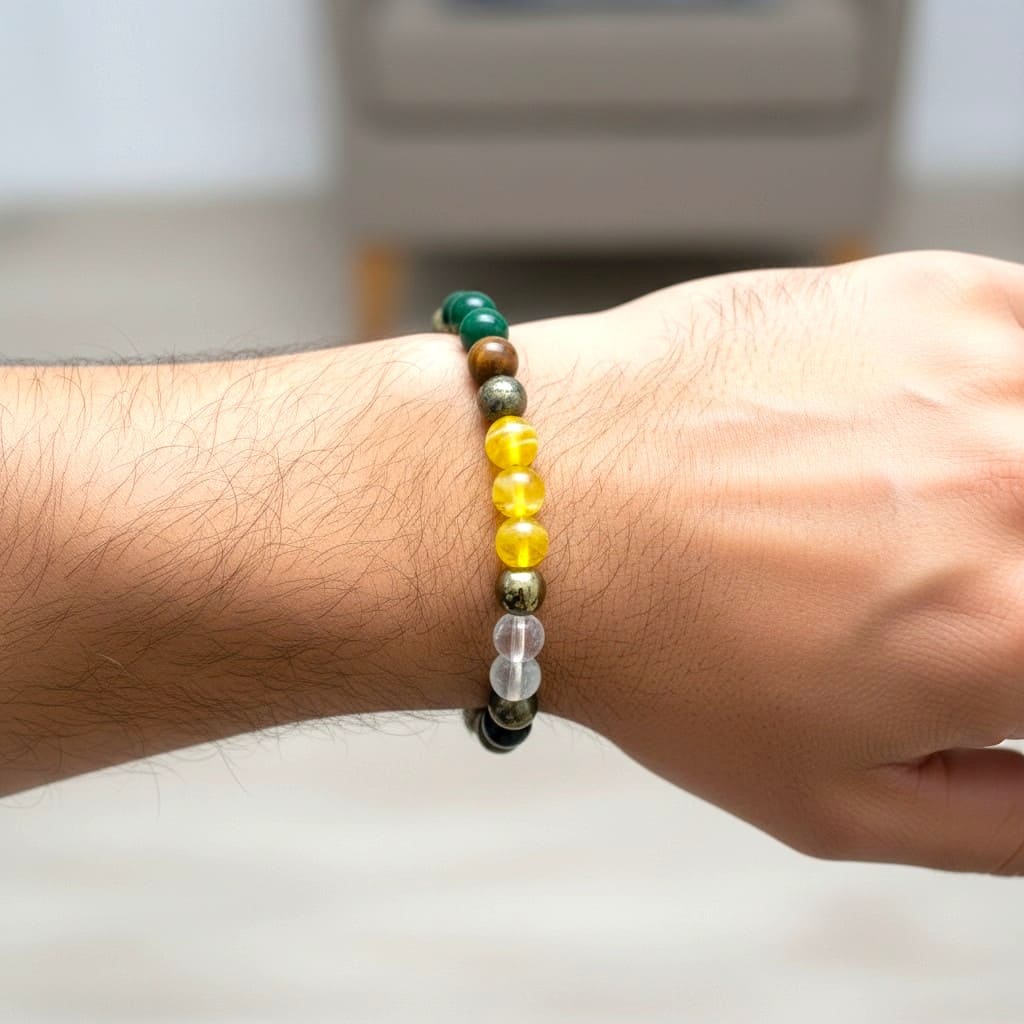 Close-up of a wrist wearing a money wealth bracelet with green, yellow, and black beads.